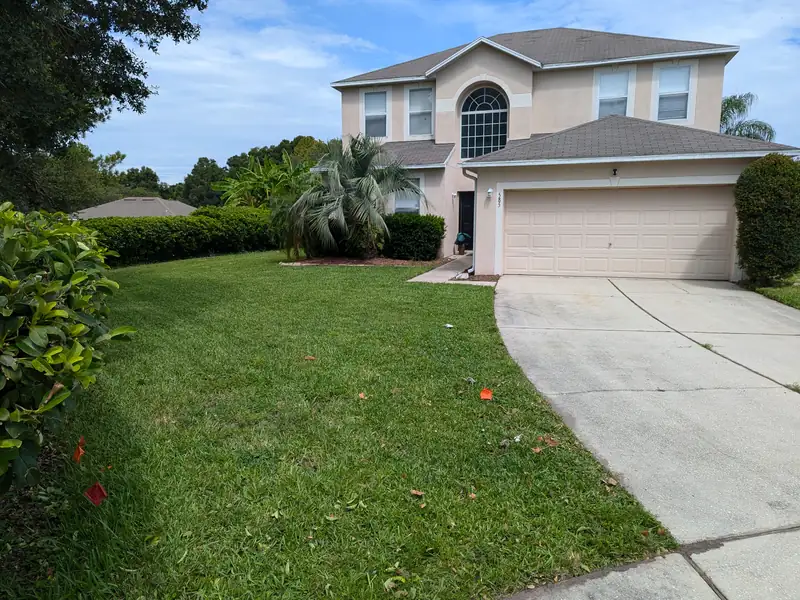 Cut and edged front lawn along a curved driveway